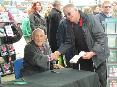 Sir Stirling Moss signing autographs